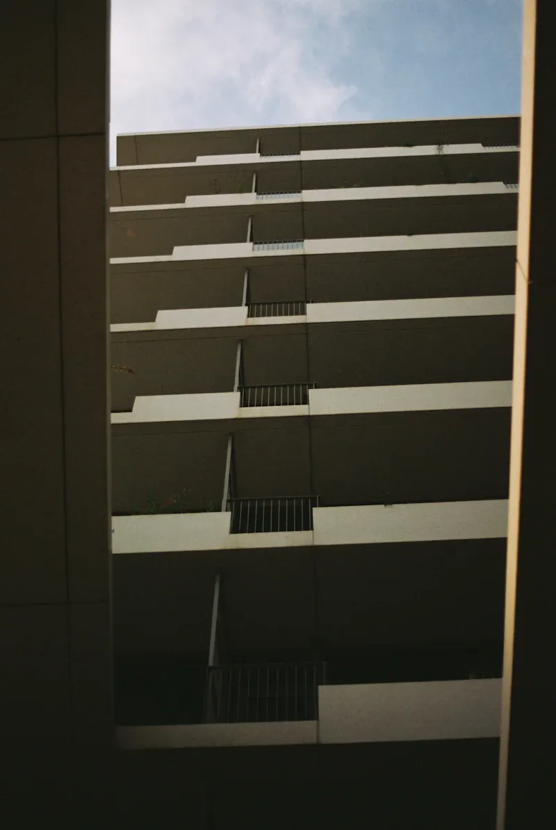 Modern Perth apartment building with moving boxes stacked near the entrance on moving day